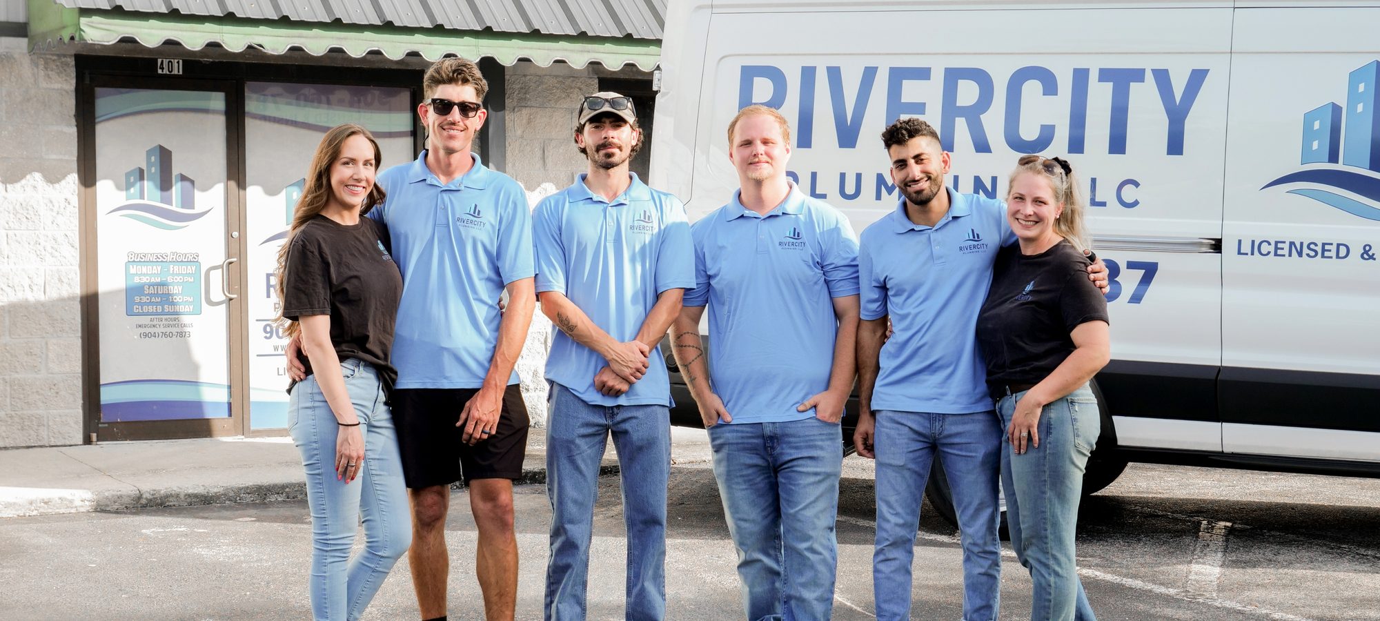 The RiverCity Plumbing team in company shirts in front of the branded service van at the Historic Kings Rd office in Jacksonville, FL